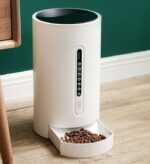 Modern smart pet feeder for cats and dogs with automatic food dispenser on a wooden floor, ready to serve pet meals.