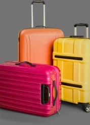 A trio of luggage in various colors, perfect for travel enthusiasts seeking stylish and functional travel gear.