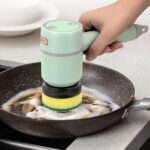 USB rechargeable electric cleaning brush removing tough stains from a frying pan.