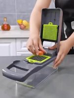 Hands using a 12 in 1 vegetable chopper for dicing a carrot in a clean, modern kitchen